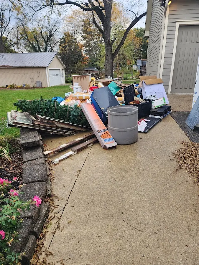 Dumpster being loaded with debris for Estate Cleanout Dumpster Rental in Monticello